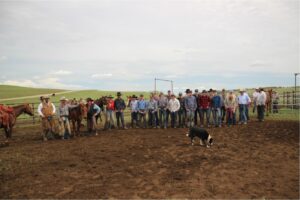Group of people lined up outside farm